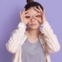 A woman touching her eyes